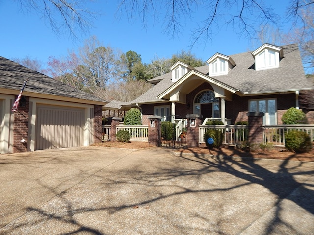 view of front of property with a garage, concrete driveway, and brick siding