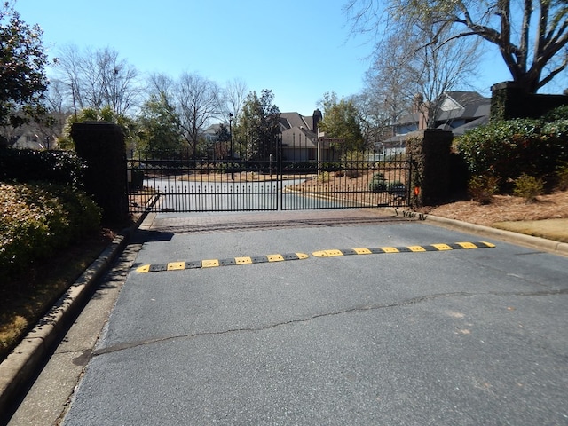 view of gate with fence and a residential view