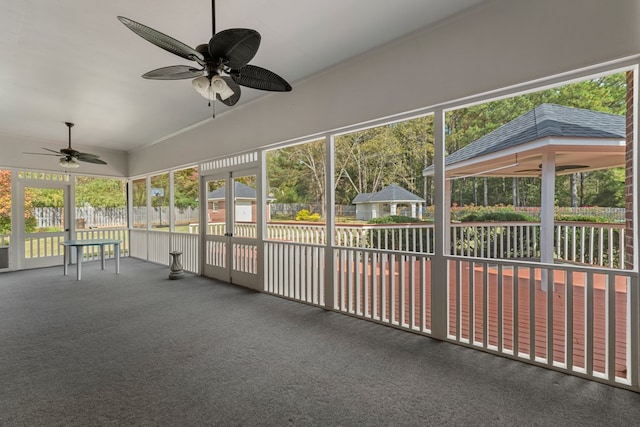 unfurnished sunroom with ceiling fan