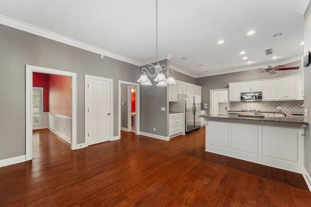 kitchen featuring white cabinetry, hanging light fixtures, dark stone counters, kitchen peninsula, and stainless steel appliances