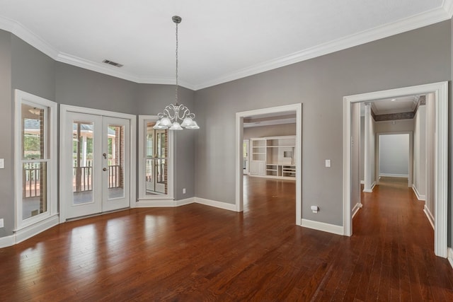 unfurnished dining area featuring visible vents, baseboards, french doors, ornamental molding, and hardwood / wood-style floors