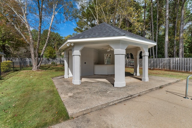 view of community with a patio area, a fenced backyard, a lawn, and a gazebo