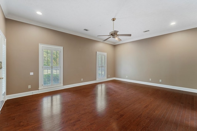 spare room featuring dark hardwood / wood-style flooring, ornamental molding, and ceiling fan