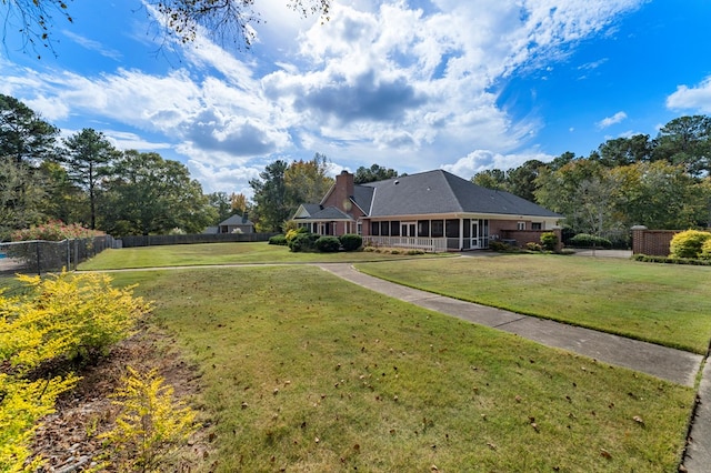 exterior space with a front yard, fence, and a chimney