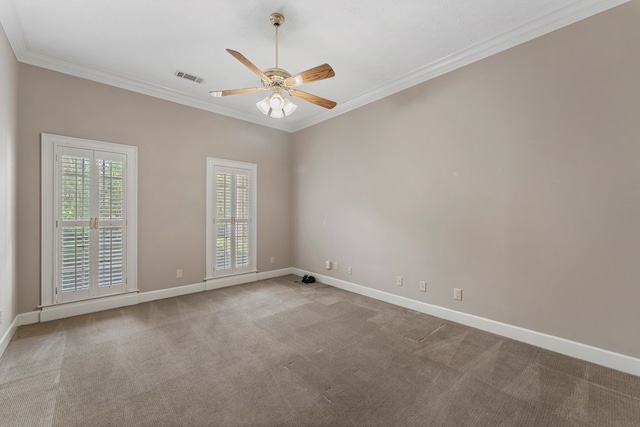 carpeted spare room with crown molding and ceiling fan