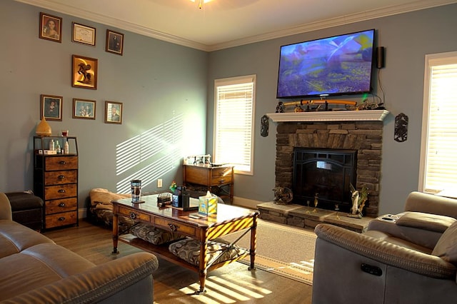 living room featuring ornamental molding, a stone fireplace, and wood-type flooring