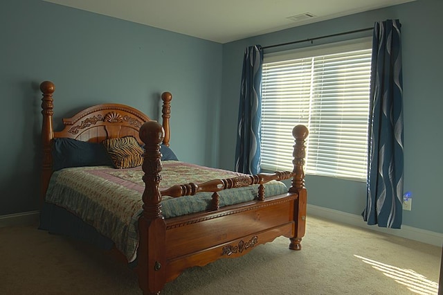 carpeted bedroom with multiple windows