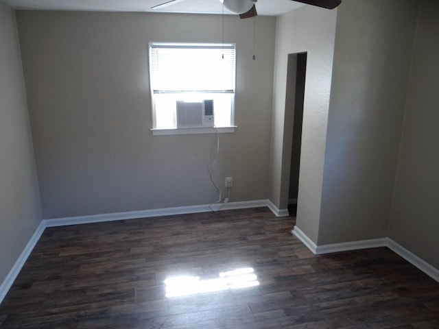 empty room featuring ceiling fan, baseboards, dark wood finished floors, and cooling unit