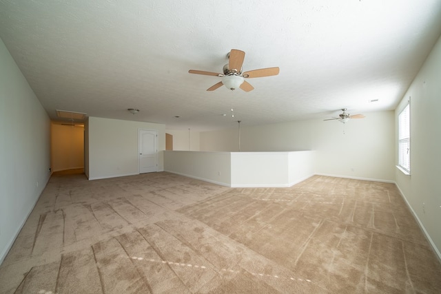 carpeted empty room with ceiling fan and a textured ceiling