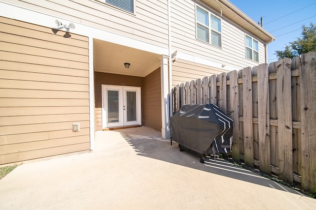 view of patio with french doors and a grill