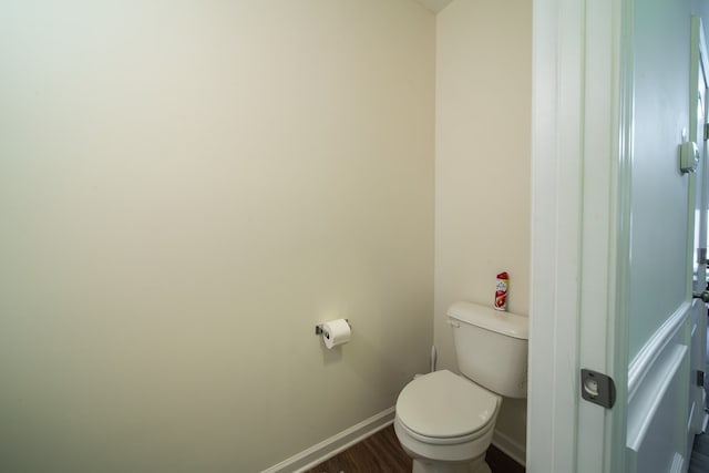 bathroom featuring toilet and wood-type flooring