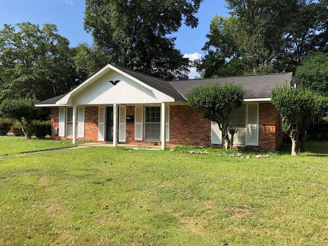 ranch-style home with a porch and a front yard