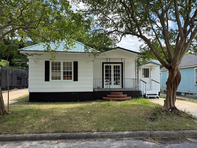 1509 12th St, Phenix City, AL 36867 - view of front of property featuring french doors, a front yard, crawl space, and a porch