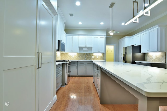 4701 Turnberry Ln Unit 12, Columbus, GA 31909 - kitchen featuring high end appliances, a sink, ornamental molding, and tasteful backsplash