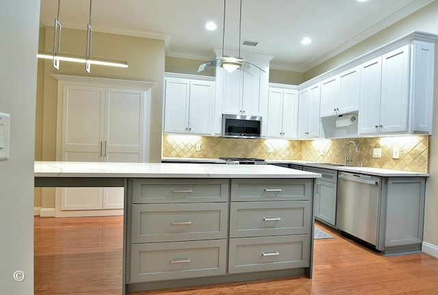4701 Turnberry Ln Unit 12, Columbus, GA 31909 - kitchen featuring gray cabinets, backsplash, appliances with stainless steel finishes, and crown molding