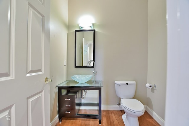 4701 Turnberry Ln Unit 12, Columbus, GA 31909 - bathroom featuring baseboards, wood finished floors, a sink, and toilet