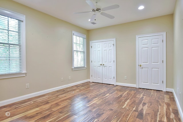 4701 Turnberry Ln Unit 12, Columbus, GA 31909 - unfurnished bedroom with baseboards, wood finished floors, and visible vents