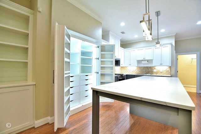 4701 Turnberry Ln Unit 12, Columbus, GA 31909 - kitchen with light wood finished floors, tasteful backsplash, ornamental molding, and stainless steel appliances