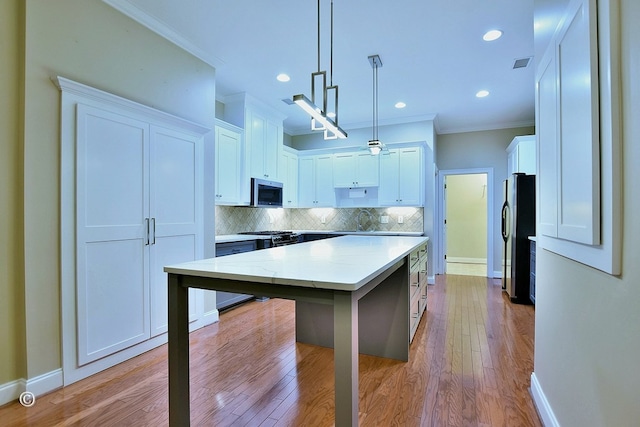 4701 Turnberry Ln Unit 12, Columbus, GA 31909 - kitchen with baseboards, appliances with stainless steel finishes, crown molding, and a sink