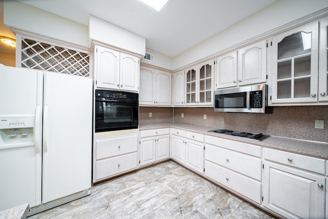 4854 Champions Way, Columbus, GA 31909 - kitchen featuring white refrigerator with ice dispenser, stainless steel microwave, oven, electric cooktop, and tasteful backsplash