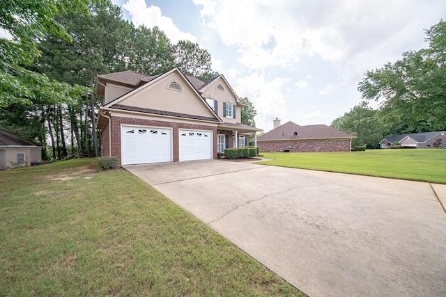 4854 Champions Way, Columbus, GA 31909 - traditional-style home with stucco siding, concrete driveway, brick siding, a front lawn, and a garage