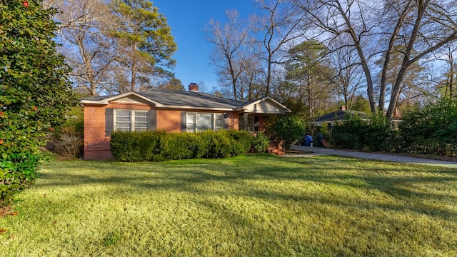 ranch-style home with a front lawn