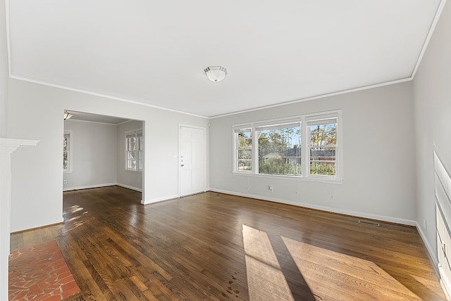 spare room with ornamental molding and dark hardwood / wood-style flooring