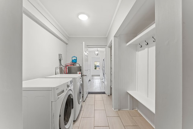 laundry room featuring washing machine and dryer and crown molding