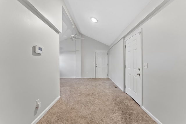 hall with light carpet and vaulted ceiling