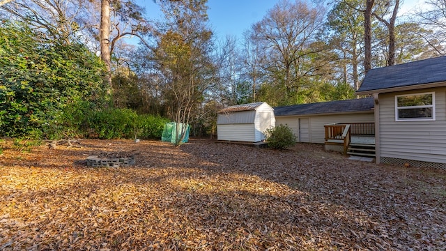 view of yard with a deck and a storage shed