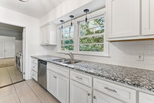 kitchen with pendant lighting, white cabinetry, sink, independent washer and dryer, and stainless steel dishwasher