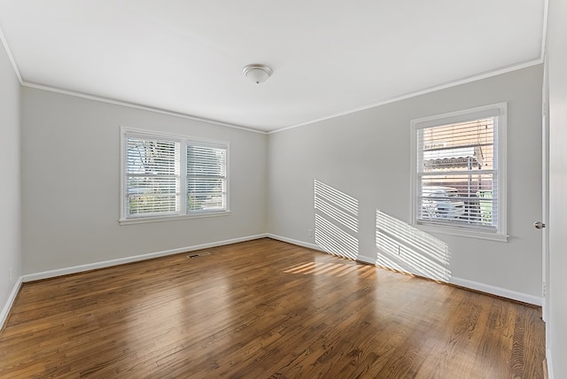 unfurnished room featuring ornamental molding, wood-type flooring, and plenty of natural light