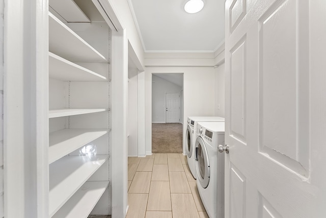 laundry room with light colored carpet, ornamental molding, and washing machine and dryer