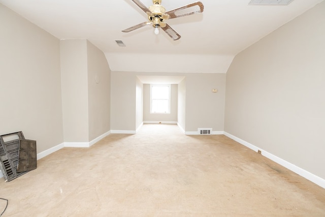 additional living space featuring a ceiling fan, baseboards, visible vents, and lofted ceiling