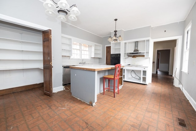 kitchen with visible vents, open shelves, brick patterned floor, a notable chandelier, and black oven