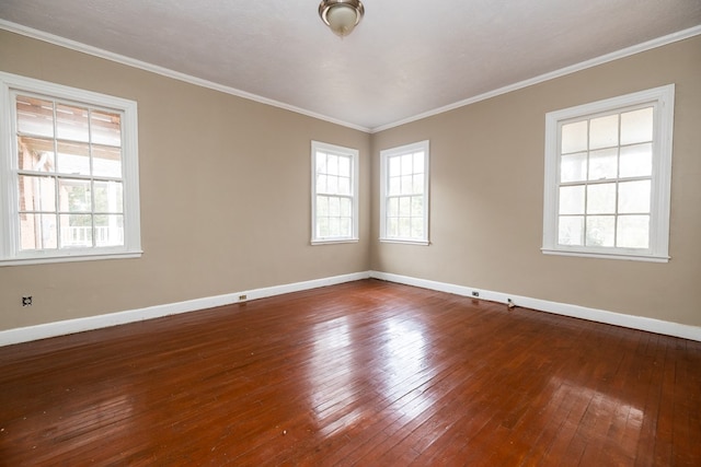 unfurnished room with wood-type flooring, baseboards, crown molding, and a healthy amount of sunlight