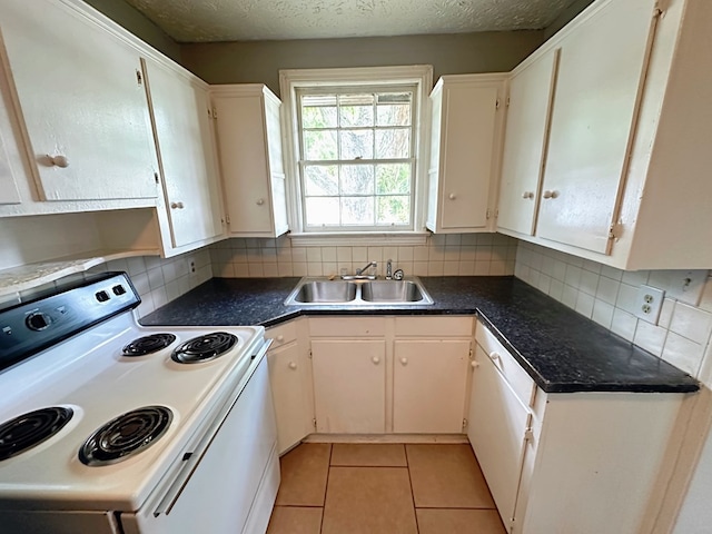 kitchen featuring sink, light tile patterned floors, backsplash, white range with electric cooktop, and white cabinets