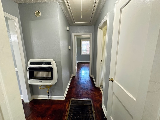 hall with dark hardwood / wood-style flooring and heating unit