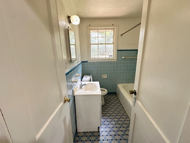 full bathroom featuring vanity, bathing tub / shower combination, tile patterned floors, toilet, and tile walls