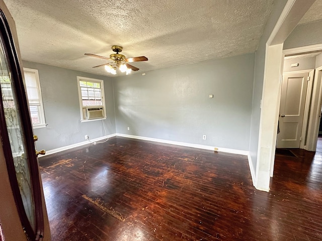 unfurnished room with a textured ceiling, dark hardwood / wood-style floors, ceiling fan, and cooling unit