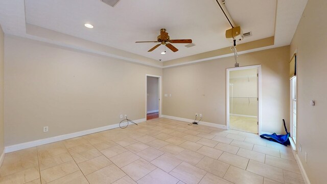 5007 Spyglass Ct, Columbus, GA 31909 - unfurnished room with a tray ceiling, light tile patterned flooring, baseboards, and a ceiling fan