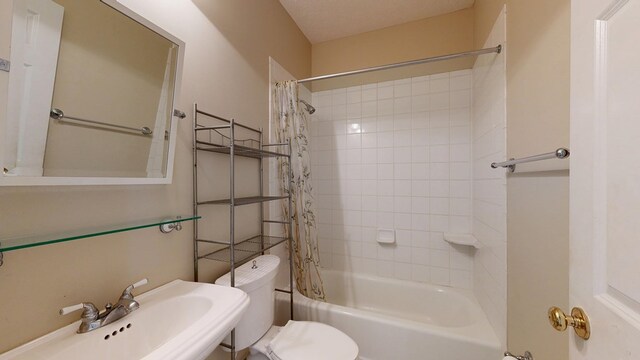 5007 Spyglass Ct, Columbus, GA 31909 - bathroom featuring shower / bath combo with shower curtain, a sink, and toilet