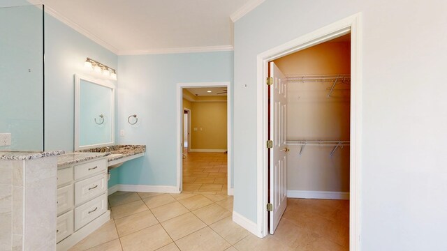5007 Spyglass Ct, Columbus, GA 31909 - bathroom featuring baseboards, ornamental molding, a walk in closet, vanity, and tile patterned flooring