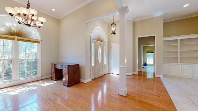 5007 Spyglass Ct, Columbus, GA 31909 - foyer with baseboards, decorative columns, a chandelier, light wood-style floors, and crown molding