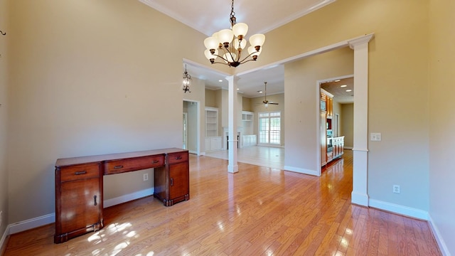 5007 Spyglass Ct, Columbus, GA 31909 - unfurnished dining area featuring baseboards, light wood-style flooring, crown molding, ornate columns, and ceiling fan with notable chandelier