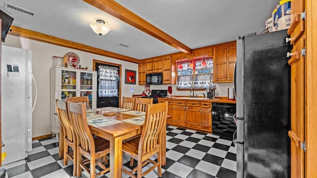 dining area with crown molding and sink