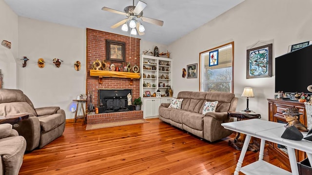 living room featuring ceiling fan and light hardwood / wood-style flooring