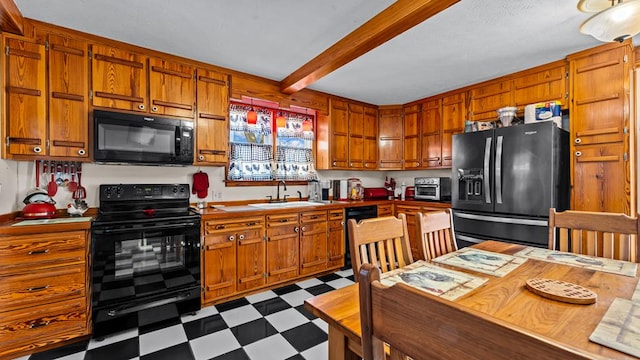 kitchen with beamed ceiling, sink, and black appliances