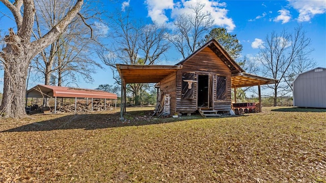 exterior space with a carport, a storage unit, and a yard