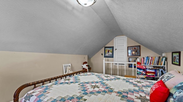 bedroom with lofted ceiling and a textured ceiling